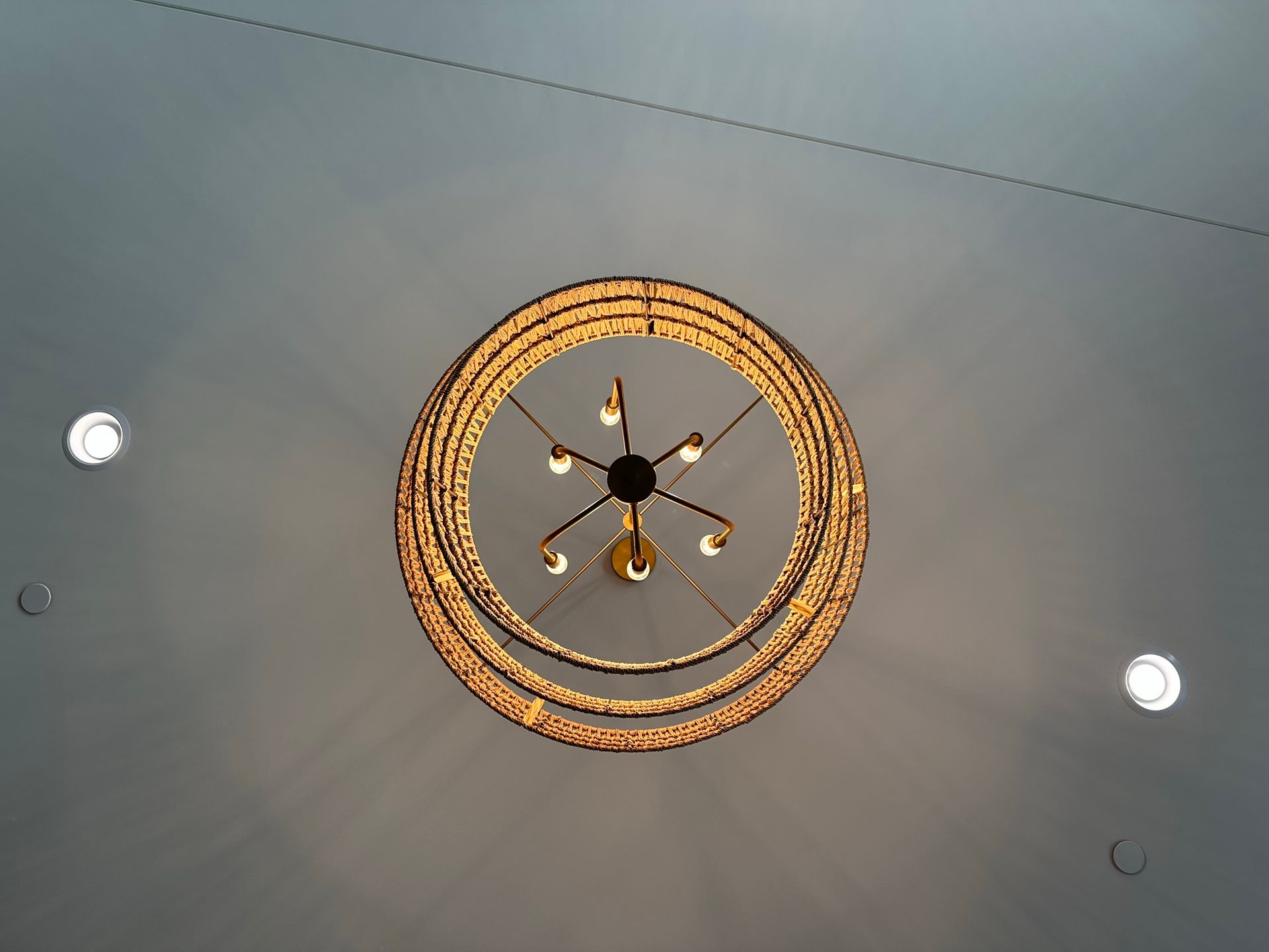 A chandelier is hanging from the ceiling in a room