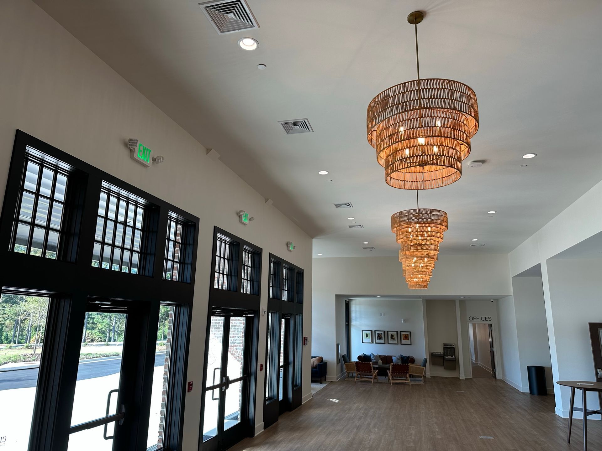 A large room with lots of windows and a chandelier hanging from the ceiling