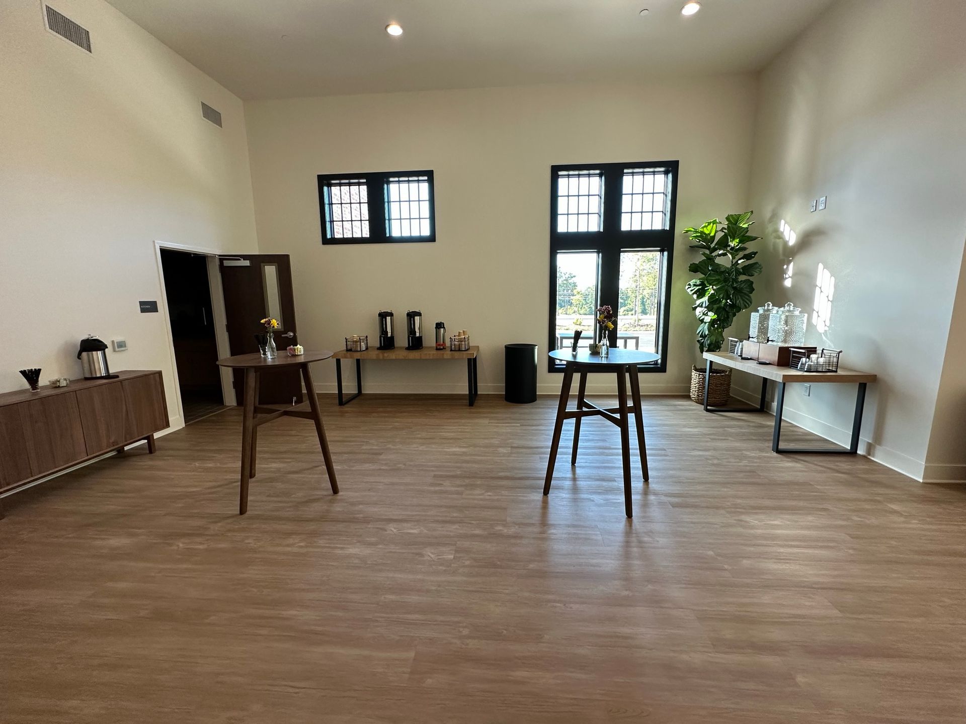A large room with wooden floors and tables in it.