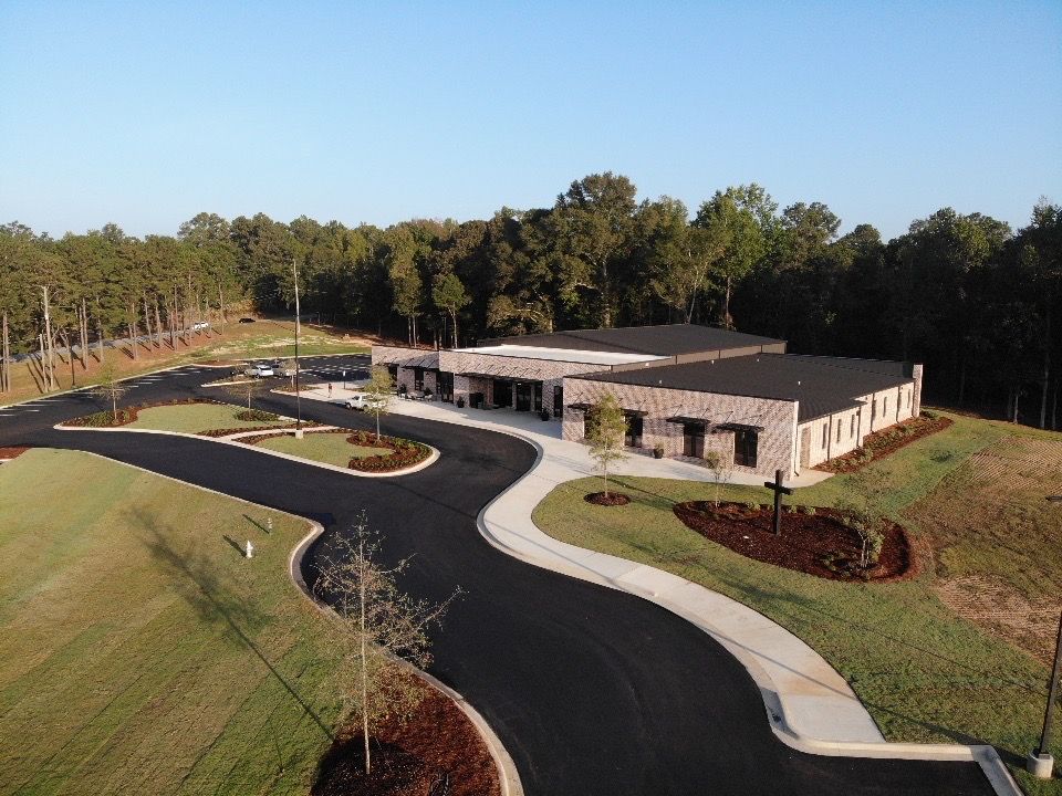 An aerial view of a large building surrounded by trees