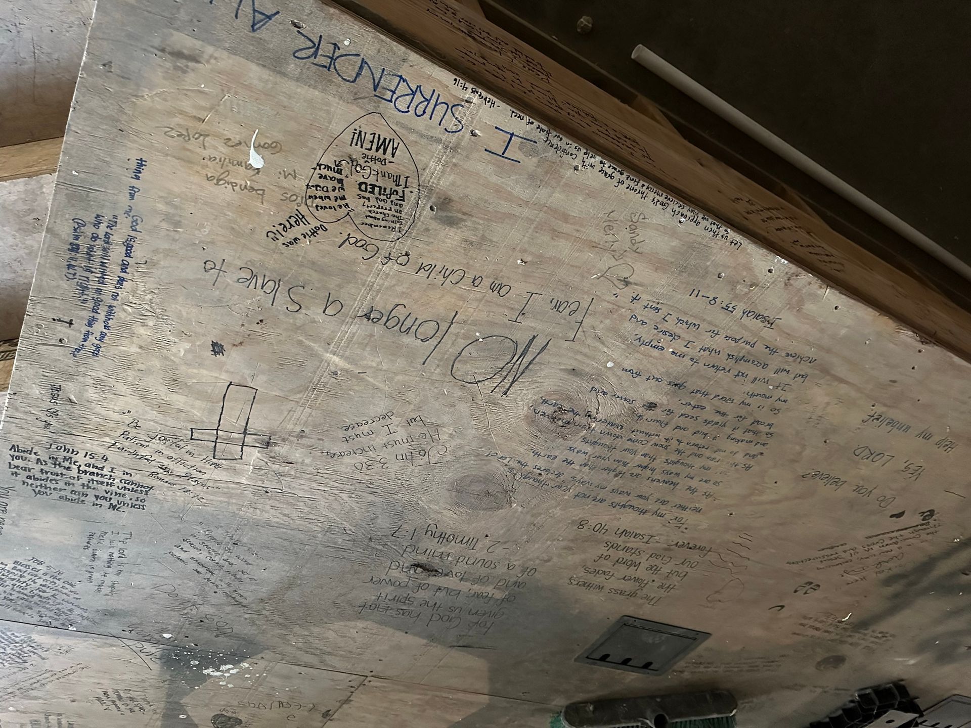 A piece of plywood with a lot of writing on it