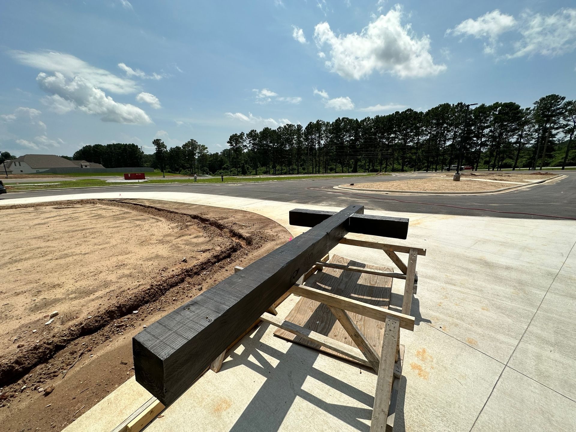 A wooden cross is sitting on a wooden table in a construction site