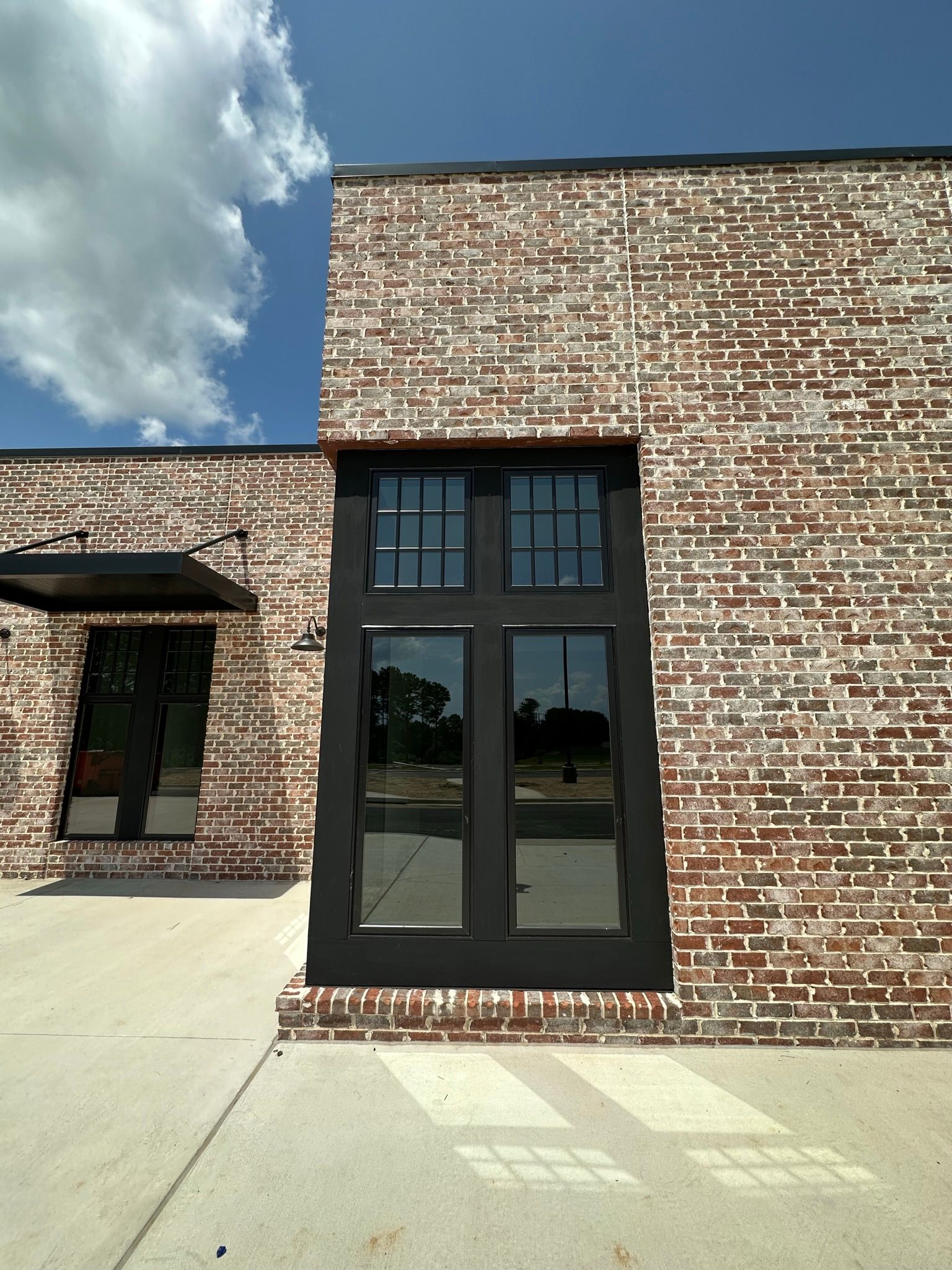 A brick building with a black door and windows