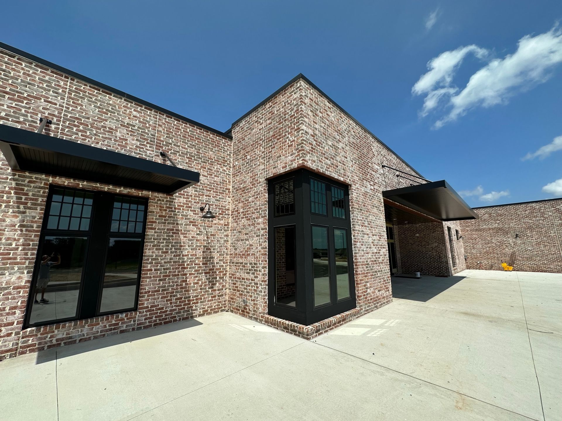 A large brick building with a lot of windows and a canopy.