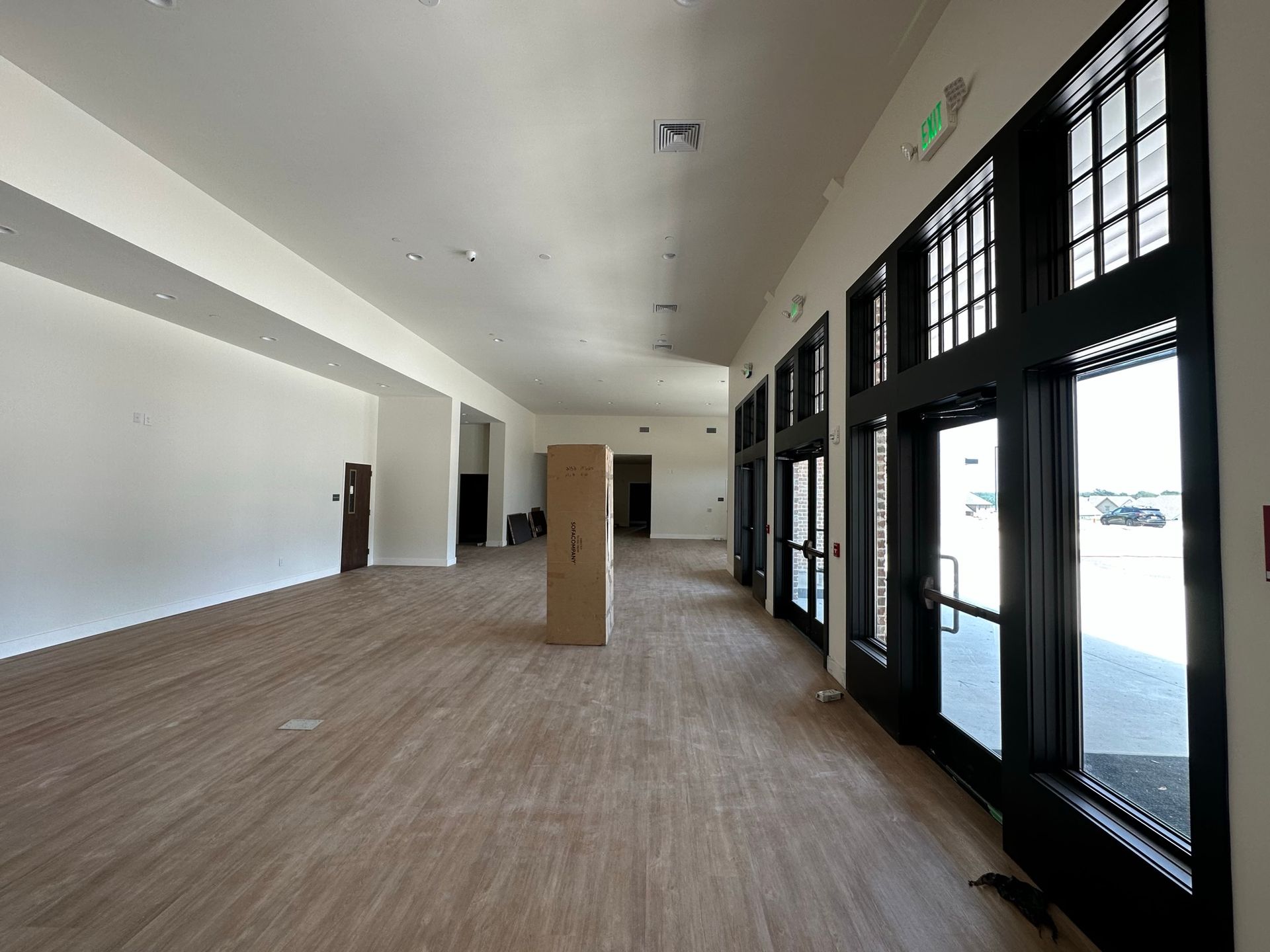 A large empty room with lots of windows and doors