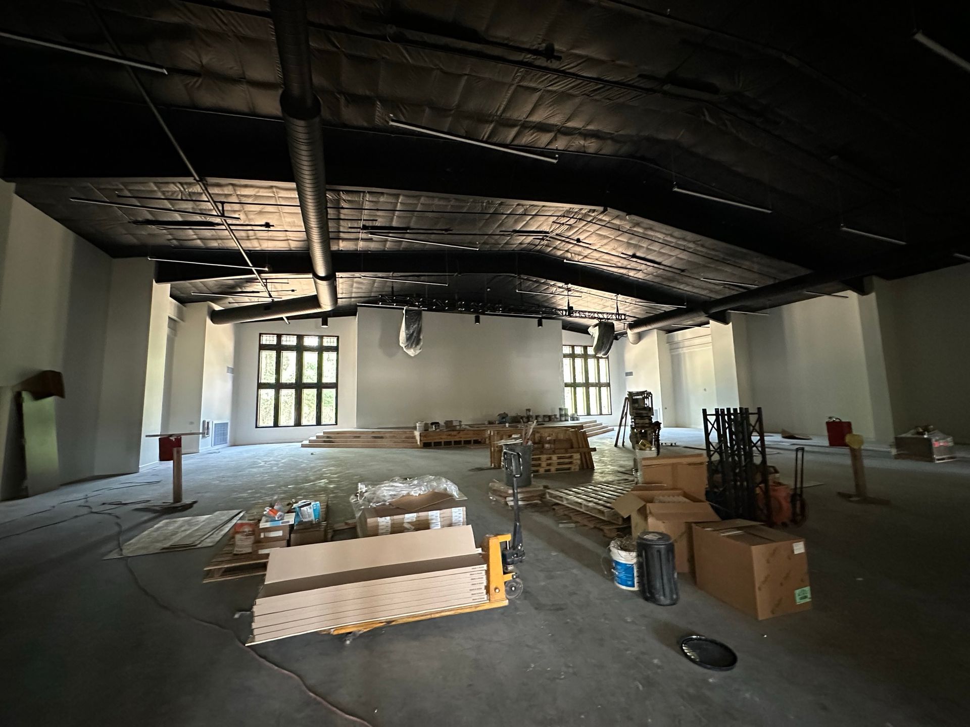 A large empty room with a lot of boxes on the floor