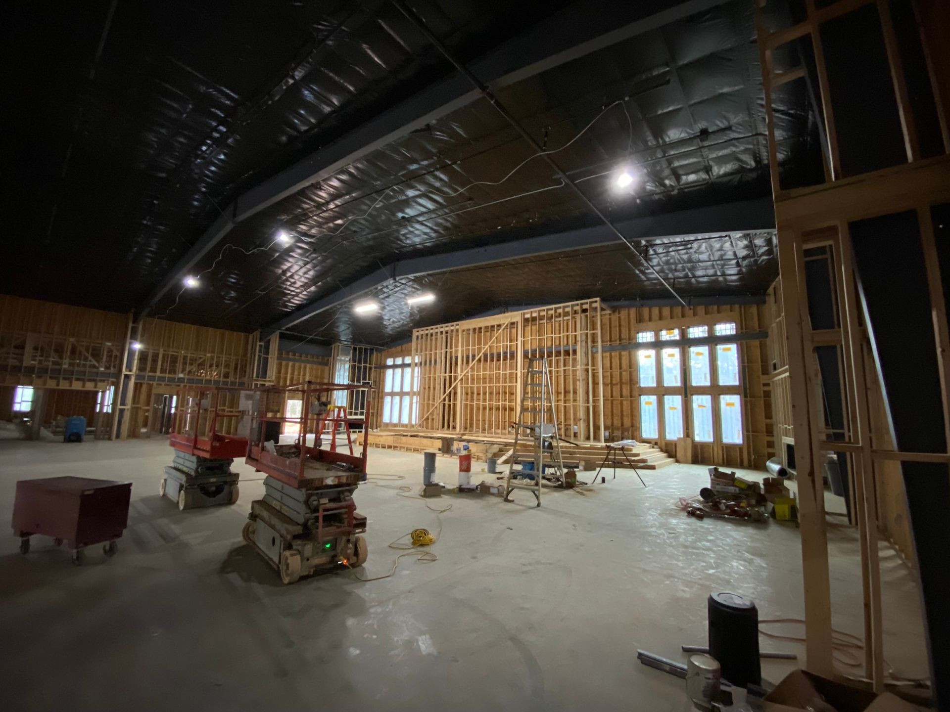 A large room with a lot of windows is being built.