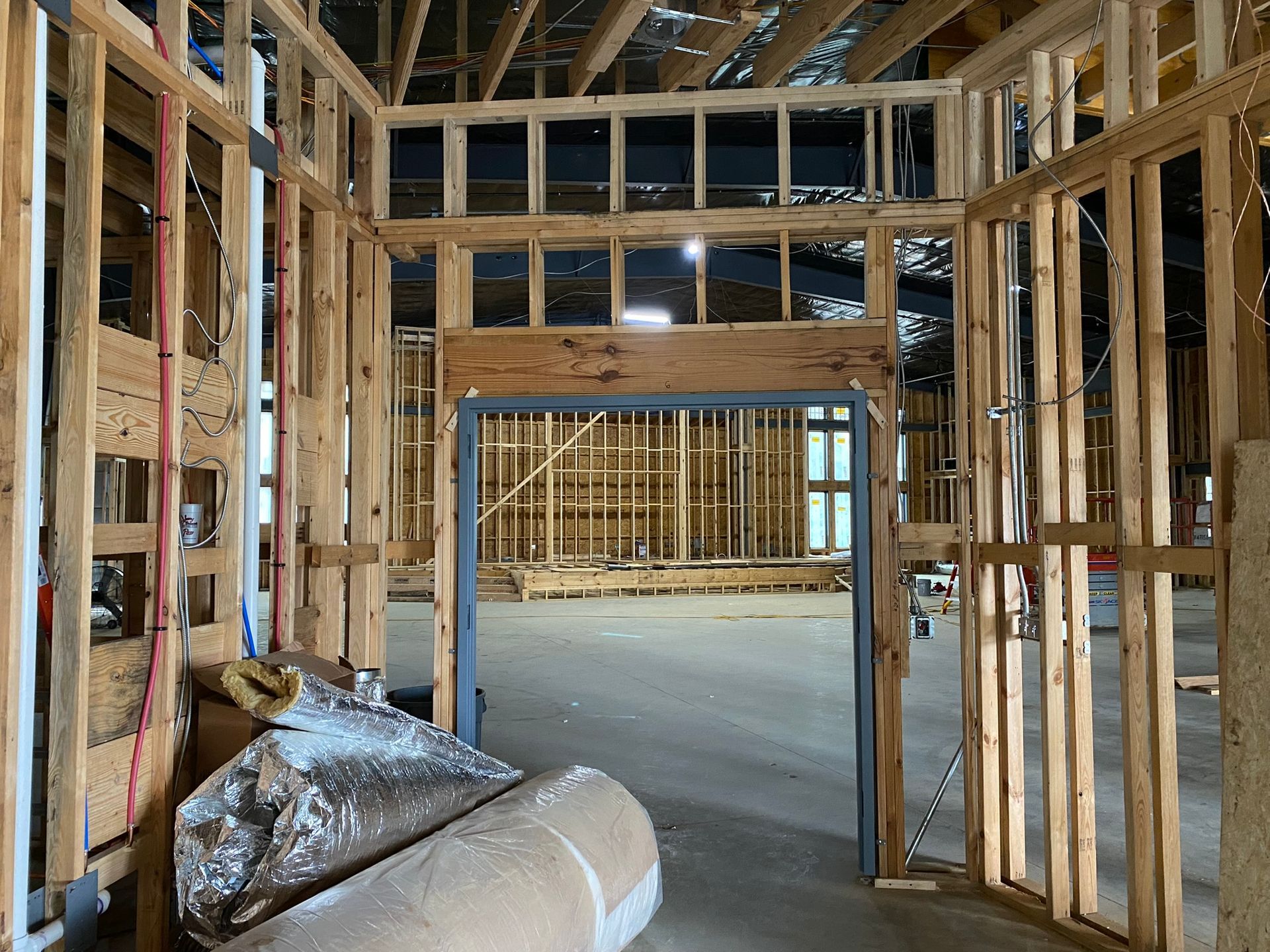 A building is being built with wooden beams and a door.