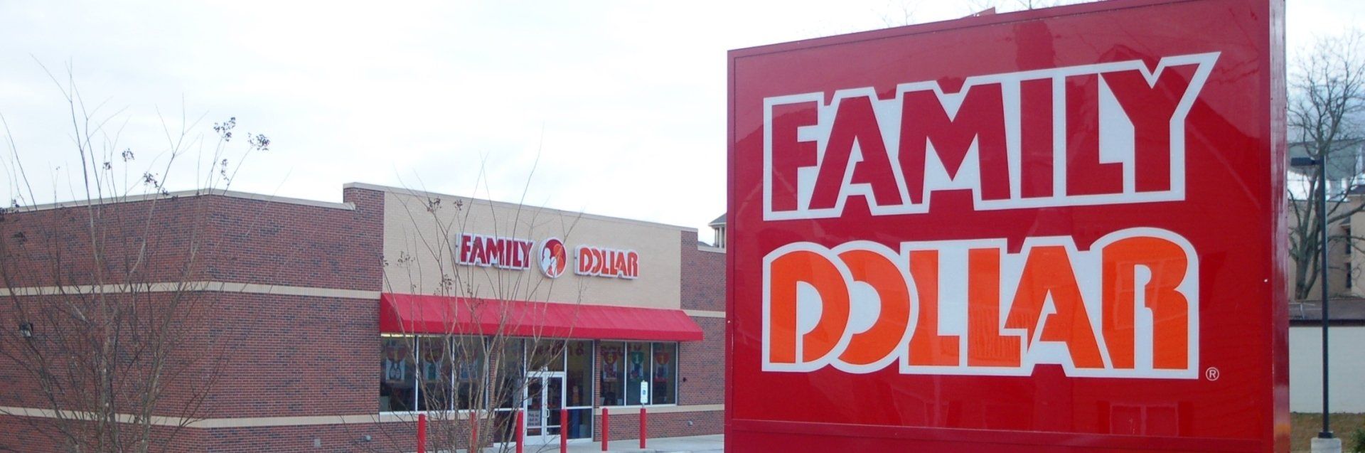 A family dollar store with a red sign in front of it