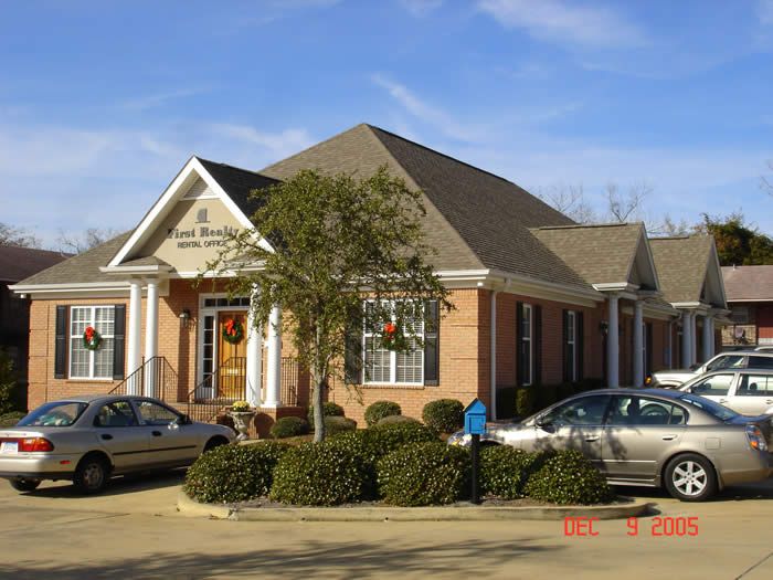 A brick building with cars parked in front of it