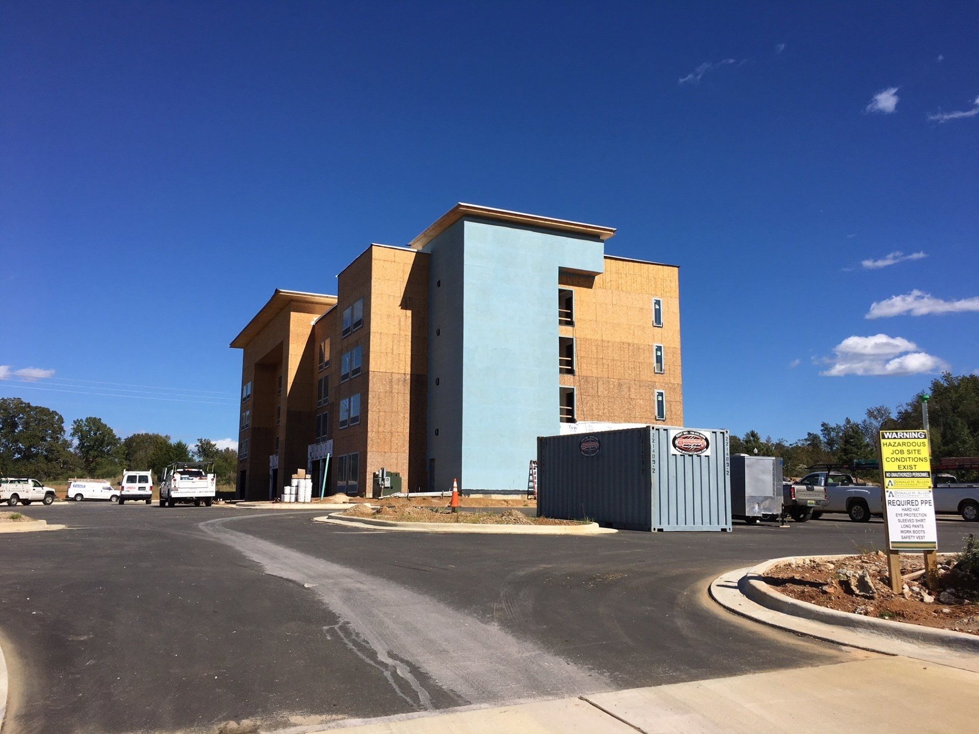 A large building is being built in a parking lot