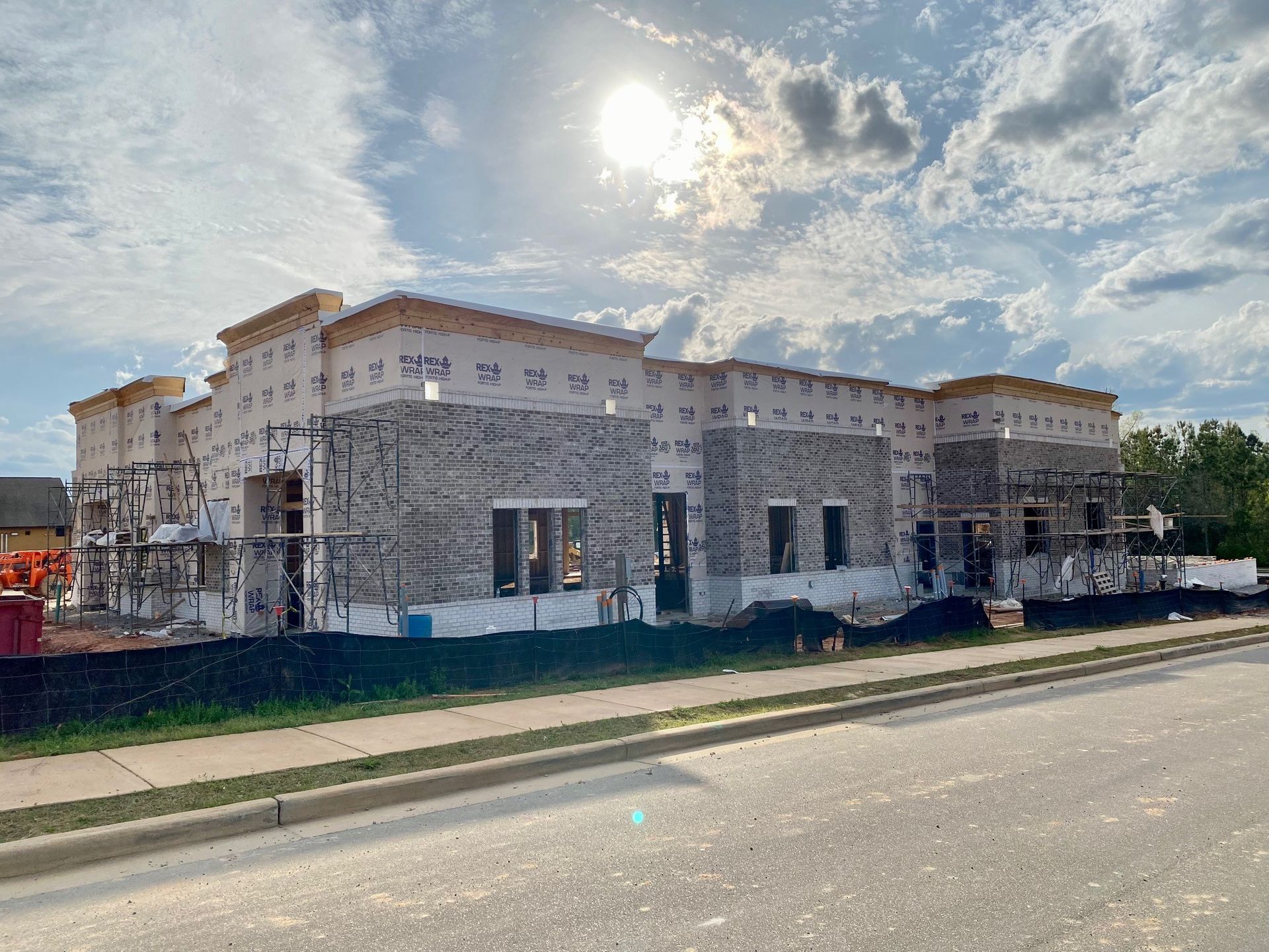 A large building is being built on the side of the road.