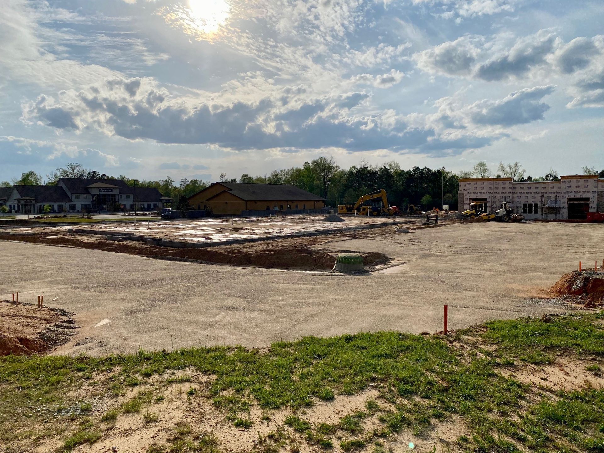 A large dirt field with a building in the background.
