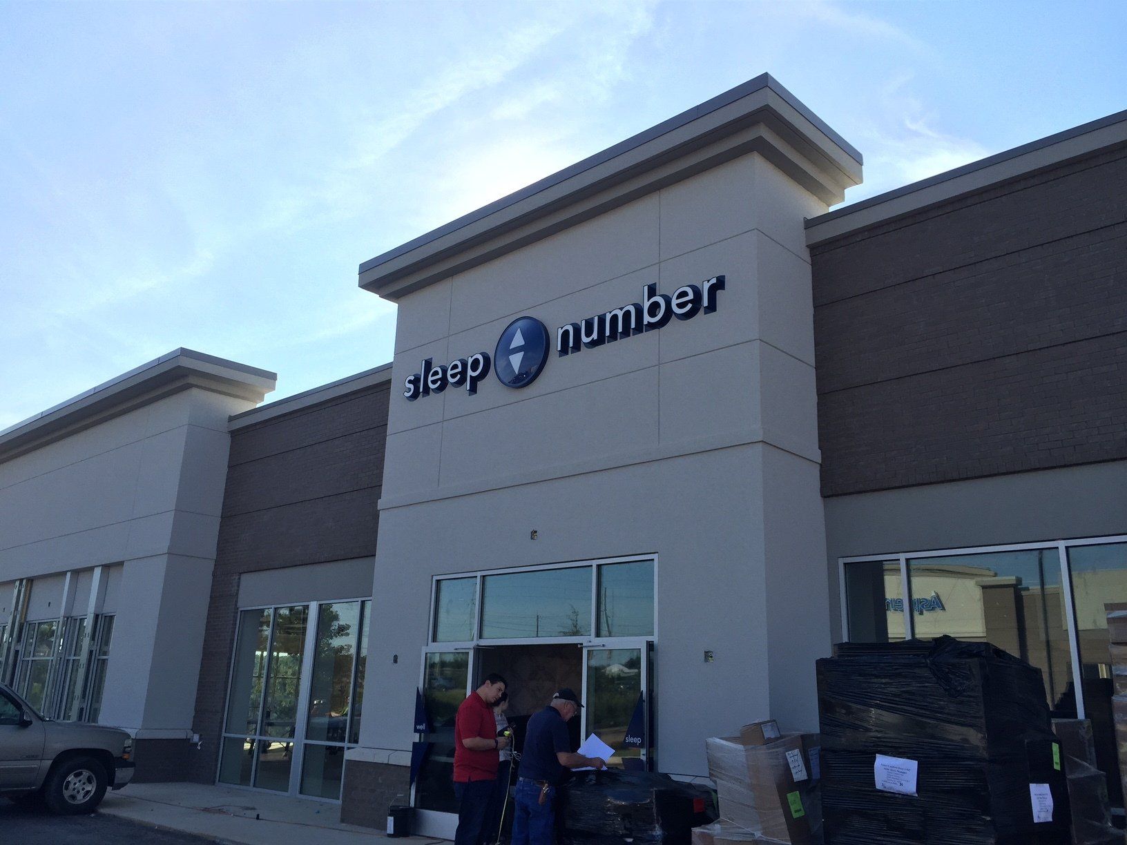 A group of people standing outside of a sleep number store