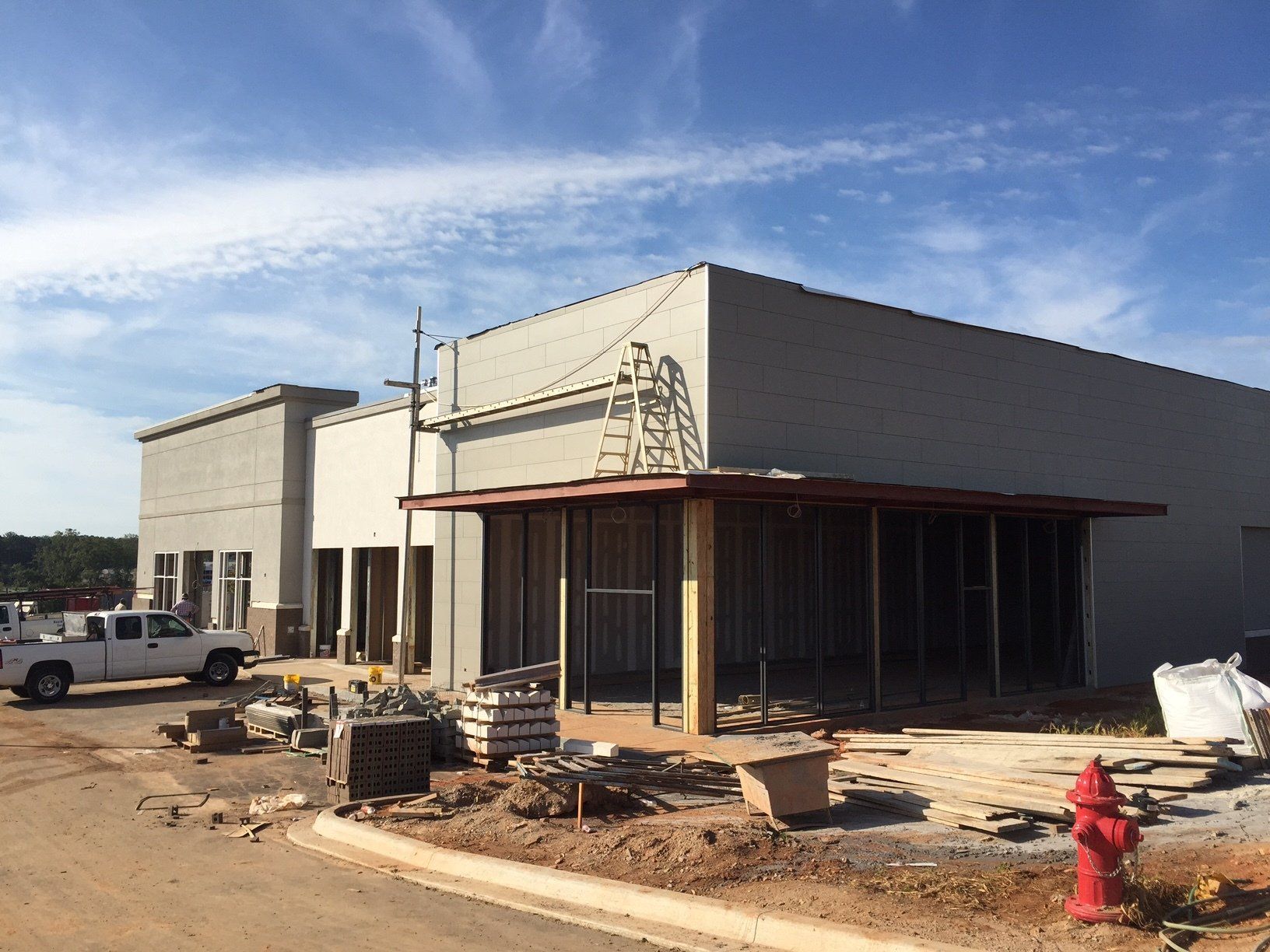 A fire hydrant is in front of a building under construction
