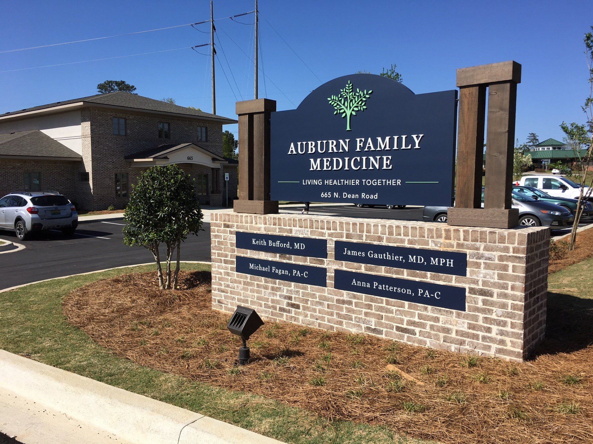 A sign for auburn family medicine is in front of a building