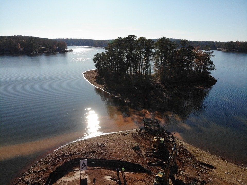 A large body of water with a small island in the middle