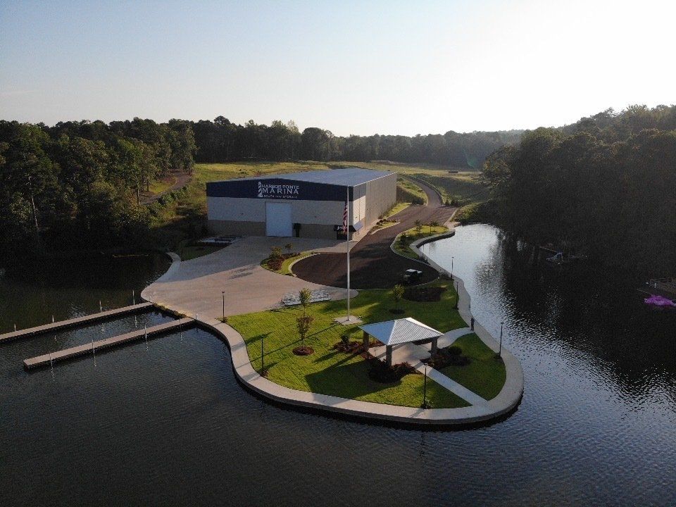 An aerial view of a building on a small island in the middle of a lake.