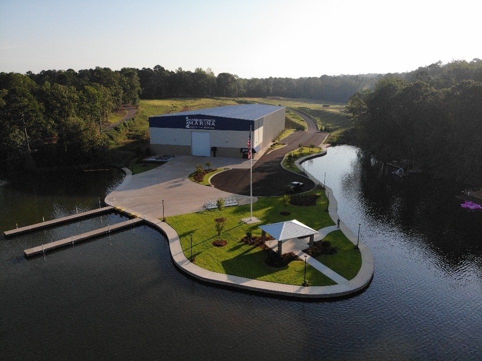 An aerial view of a building on a small island in the middle of a lake.