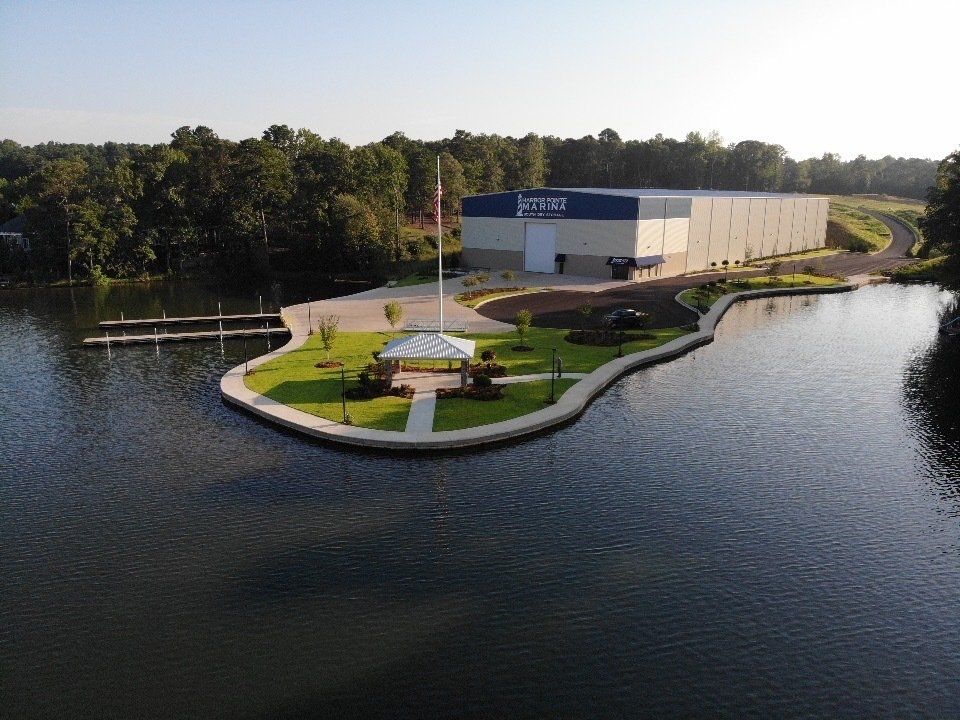 An aerial view of a building on a small island in the middle of a lake