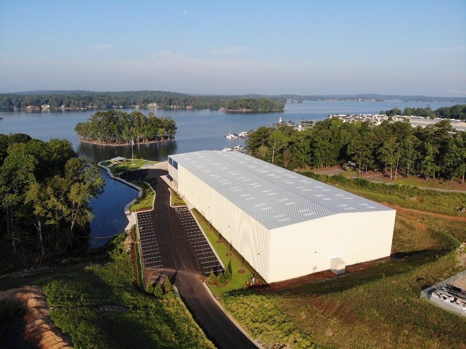 An aerial view of a large building next to a lake