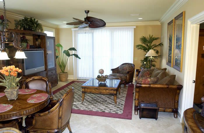A living room with furniture and a ceiling fan