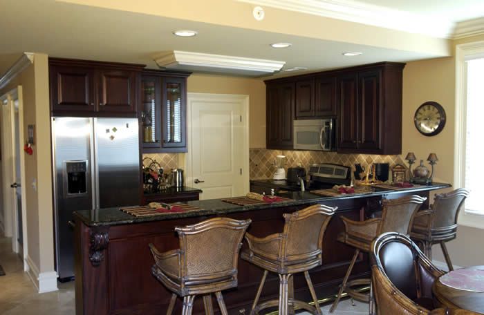 A kitchen with stainless steel appliances and wooden cabinets