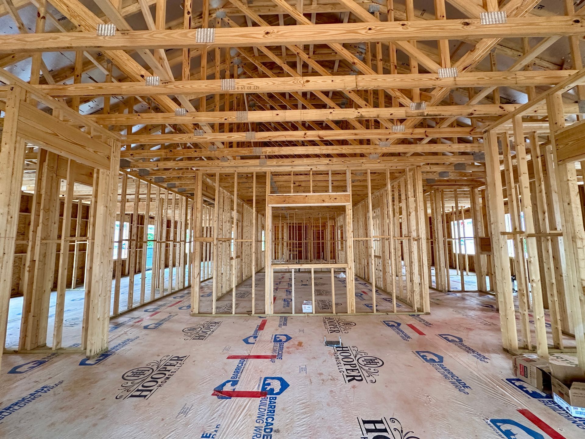 The inside of a building under construction with a lot of wooden beams.