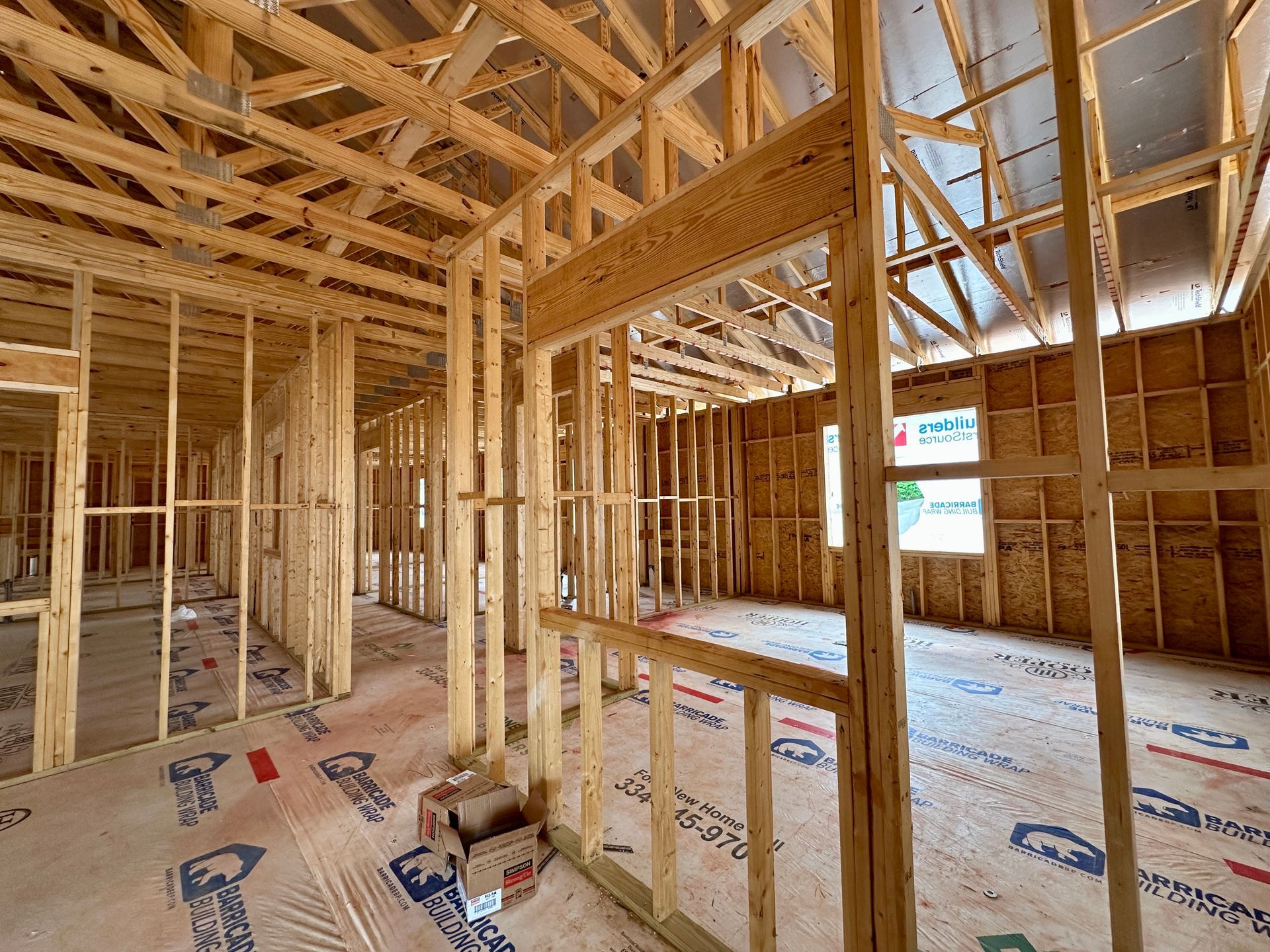 The inside of a building under construction with wooden beams.