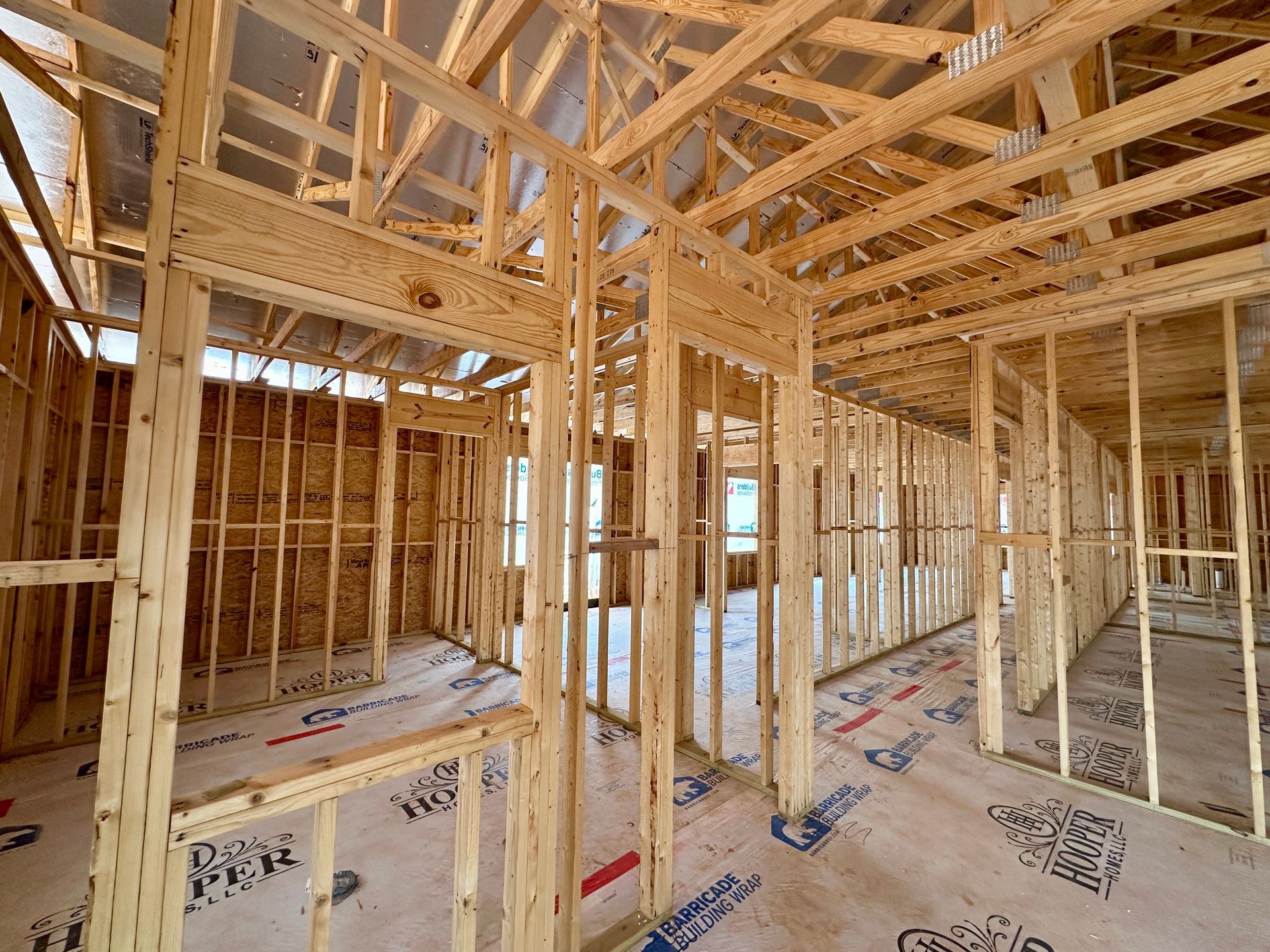 The inside of a commercial building under construction with wooden beams.