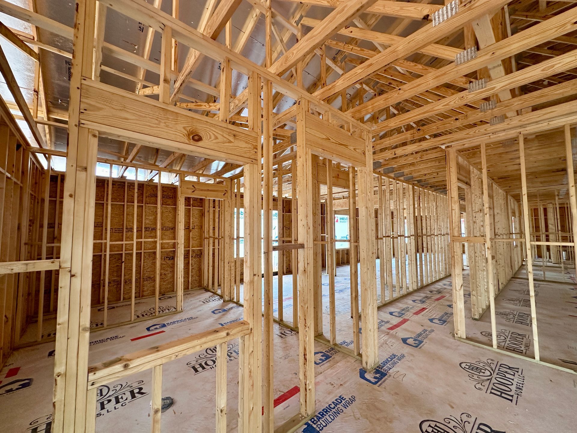 The inside of a commercial building under construction with wooden beams.
