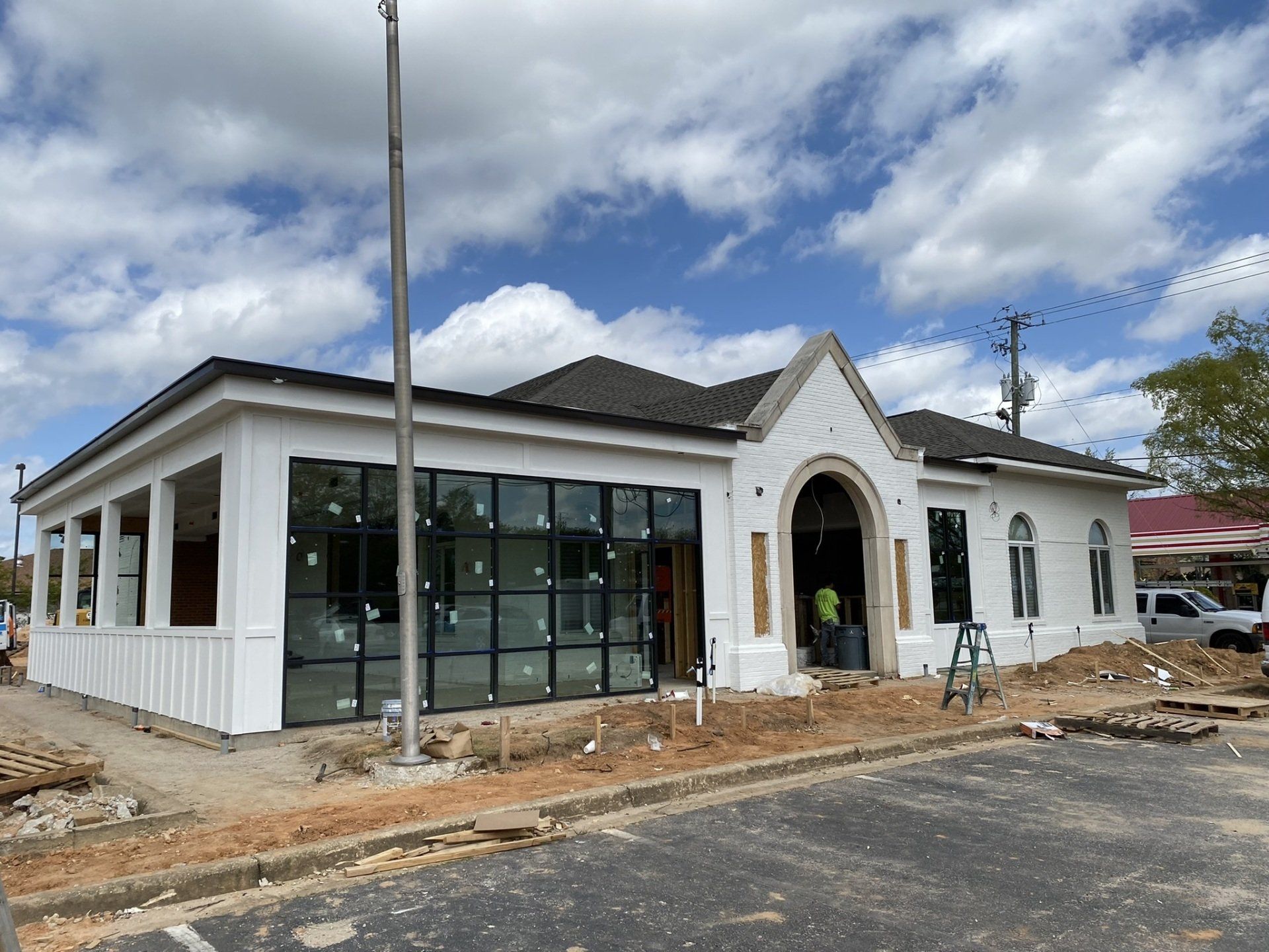 A large white building with a lot of windows is being built.
