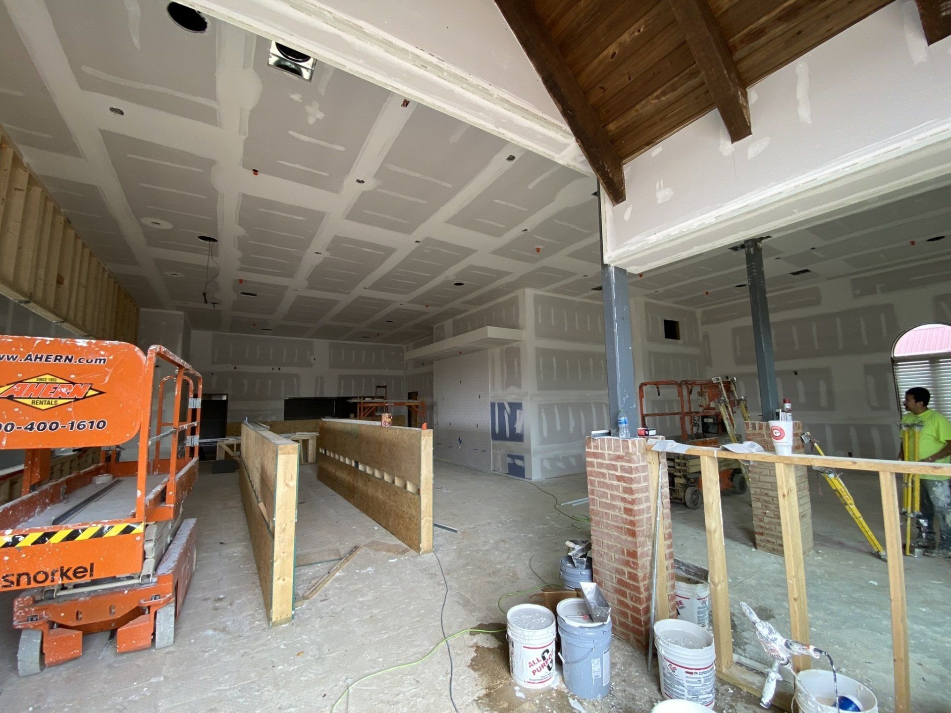 A large room with a ceiling that is being built.