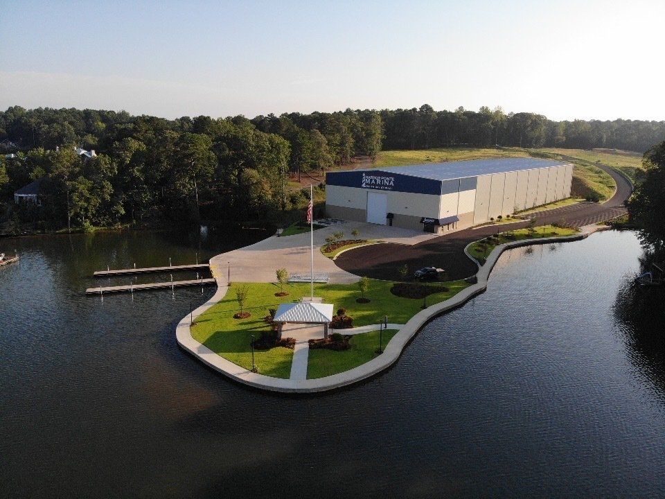 An aerial view of a building on a small island in the middle of a lake