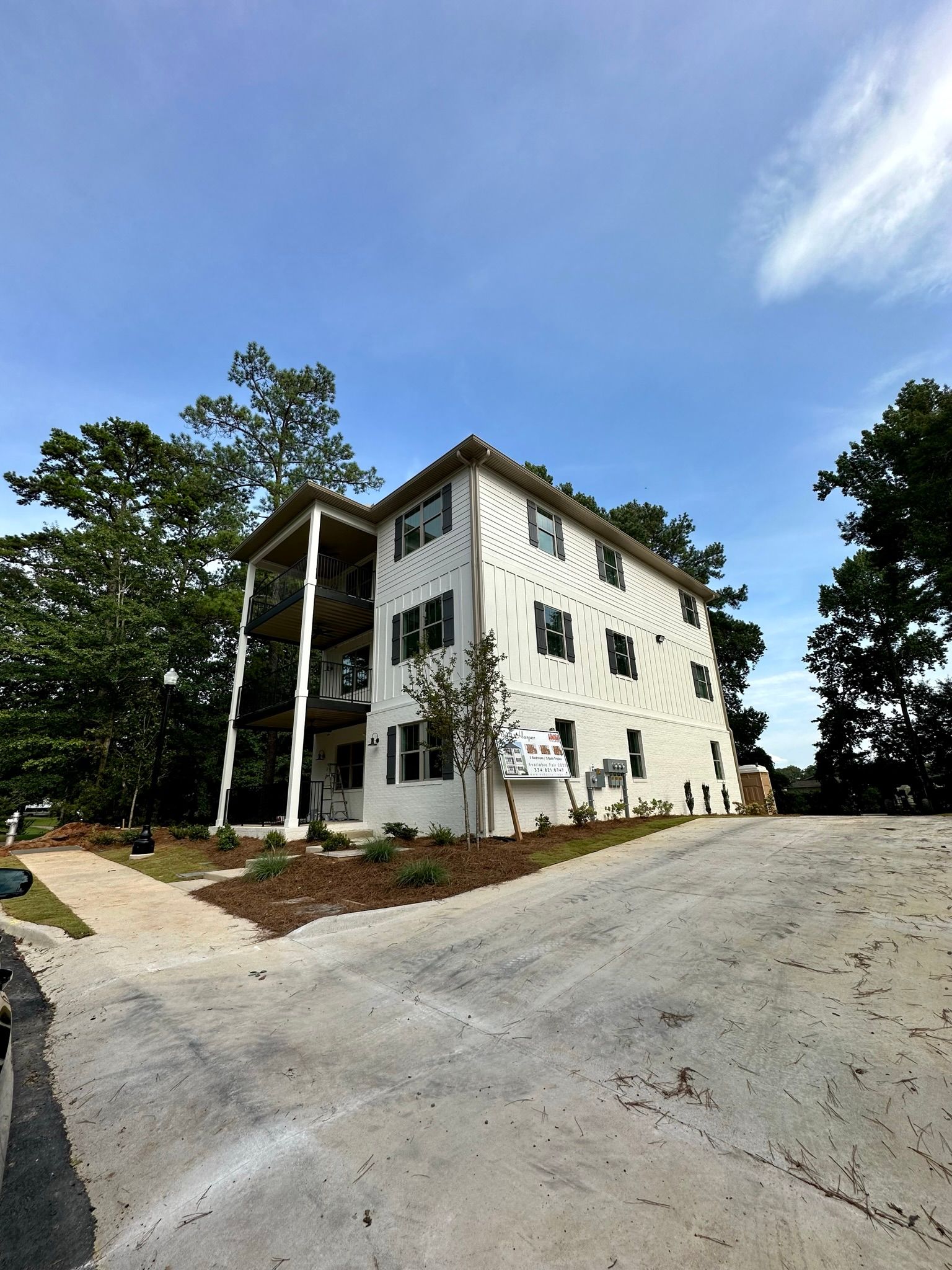 A large white building with a lot of windows is being built.