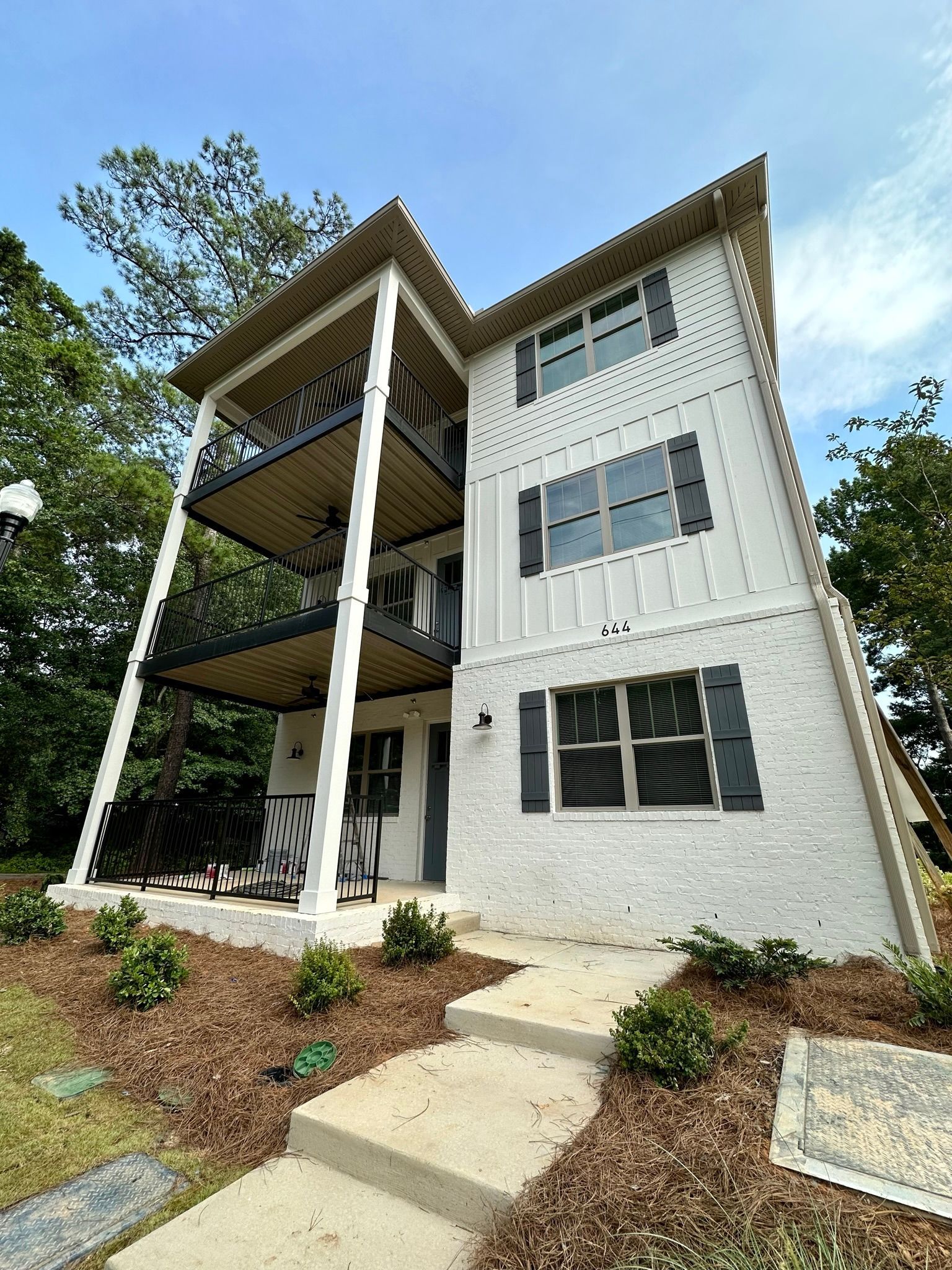 A large white house with a lot of windows and balconies.
