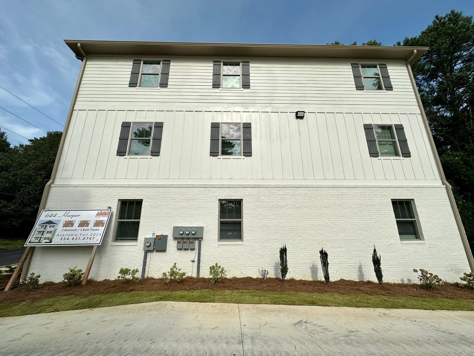 A large white building with a sign in front of it that says 