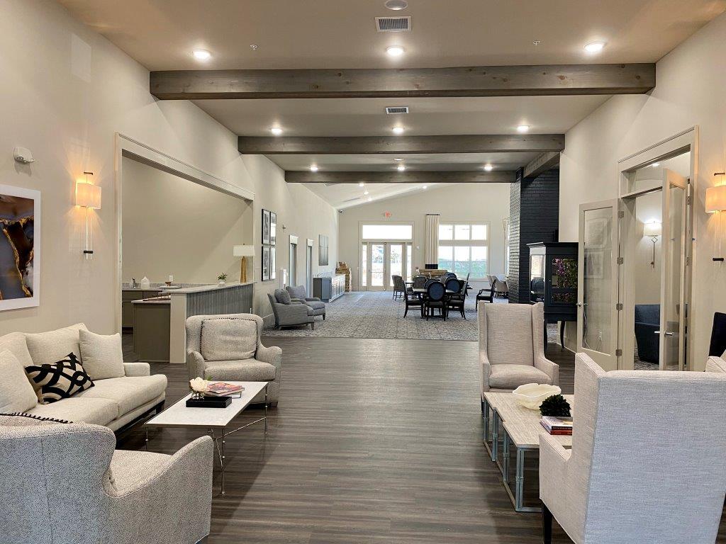 A living room with a couch , chairs , and a table.