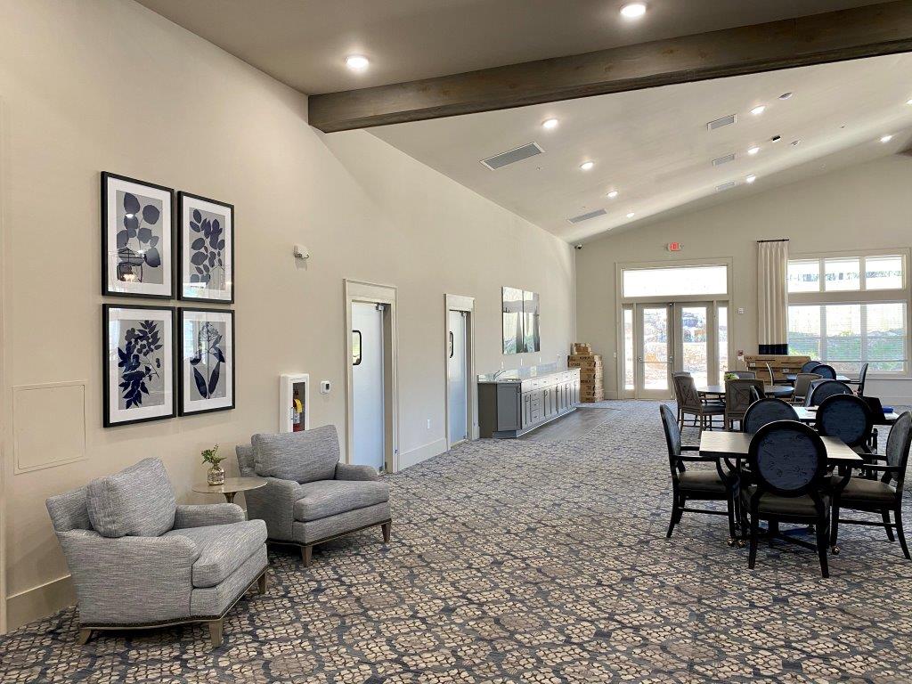 A large room with tables and chairs in it.