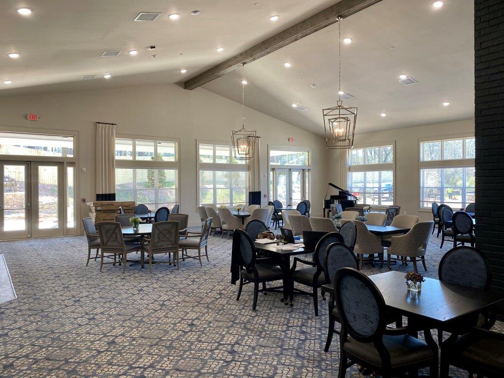 A large room filled with tables and chairs in a restaurant.