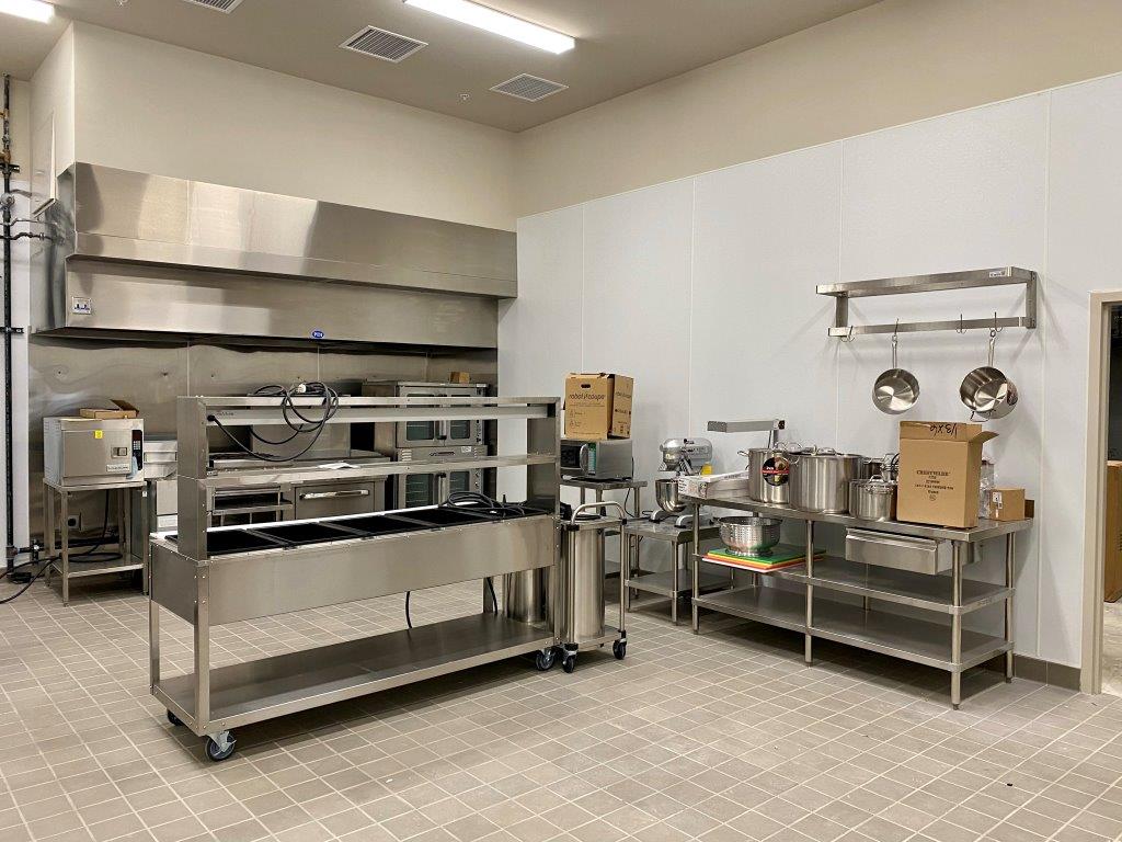 A large kitchen with a lot of stainless steel appliances.