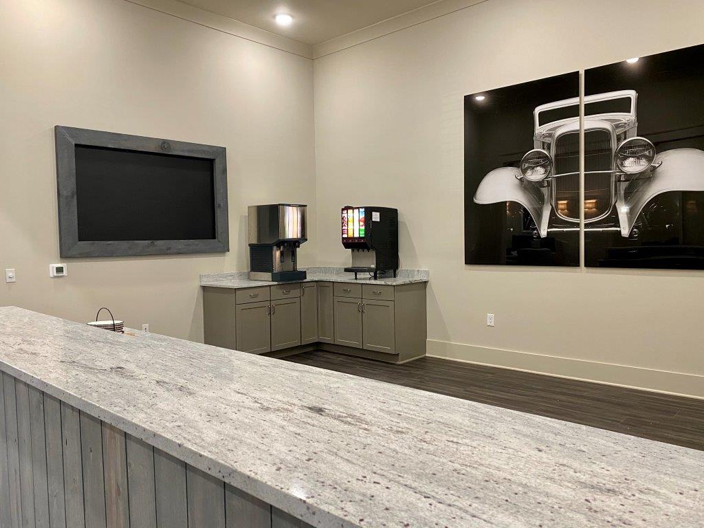 There is a picture of a car on the wall above the counter.