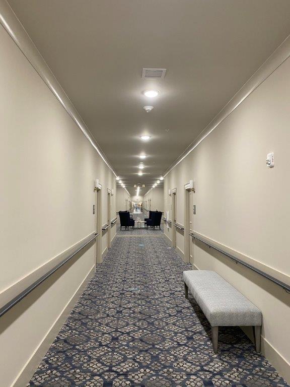 A long hallway with a bench in the middle