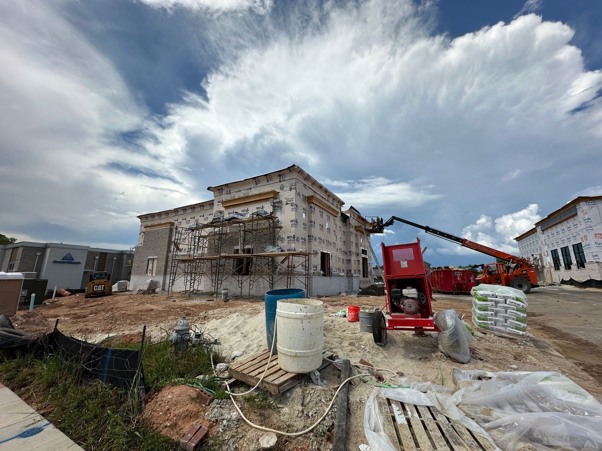 A large building under construction with a crane in the background.
