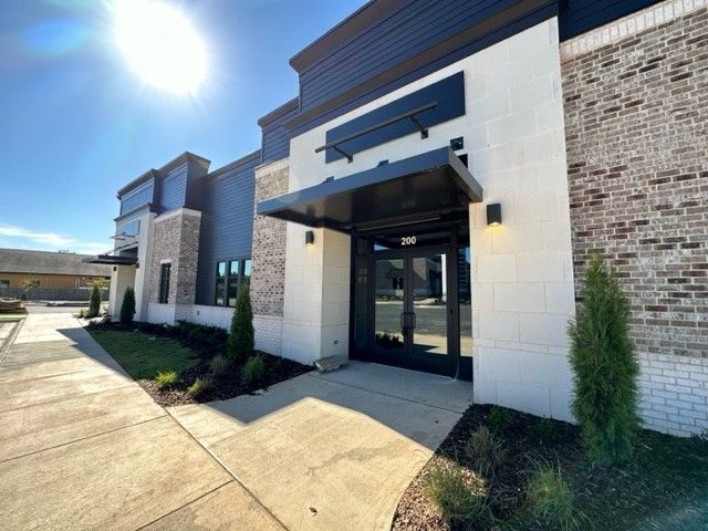A large brick building with a canopy over the entrance.