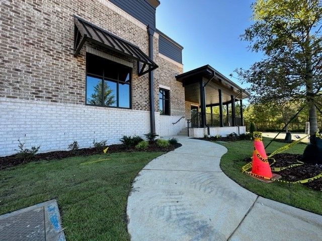 A brick building with a walkway leading to it