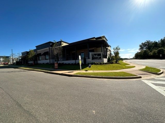 A large building is sitting on the corner of a street.