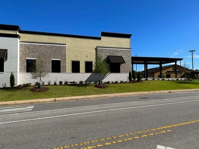 A large building is sitting on the side of a road.
