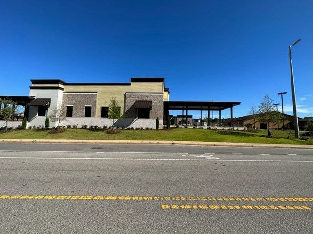 A large building sits on the side of a road