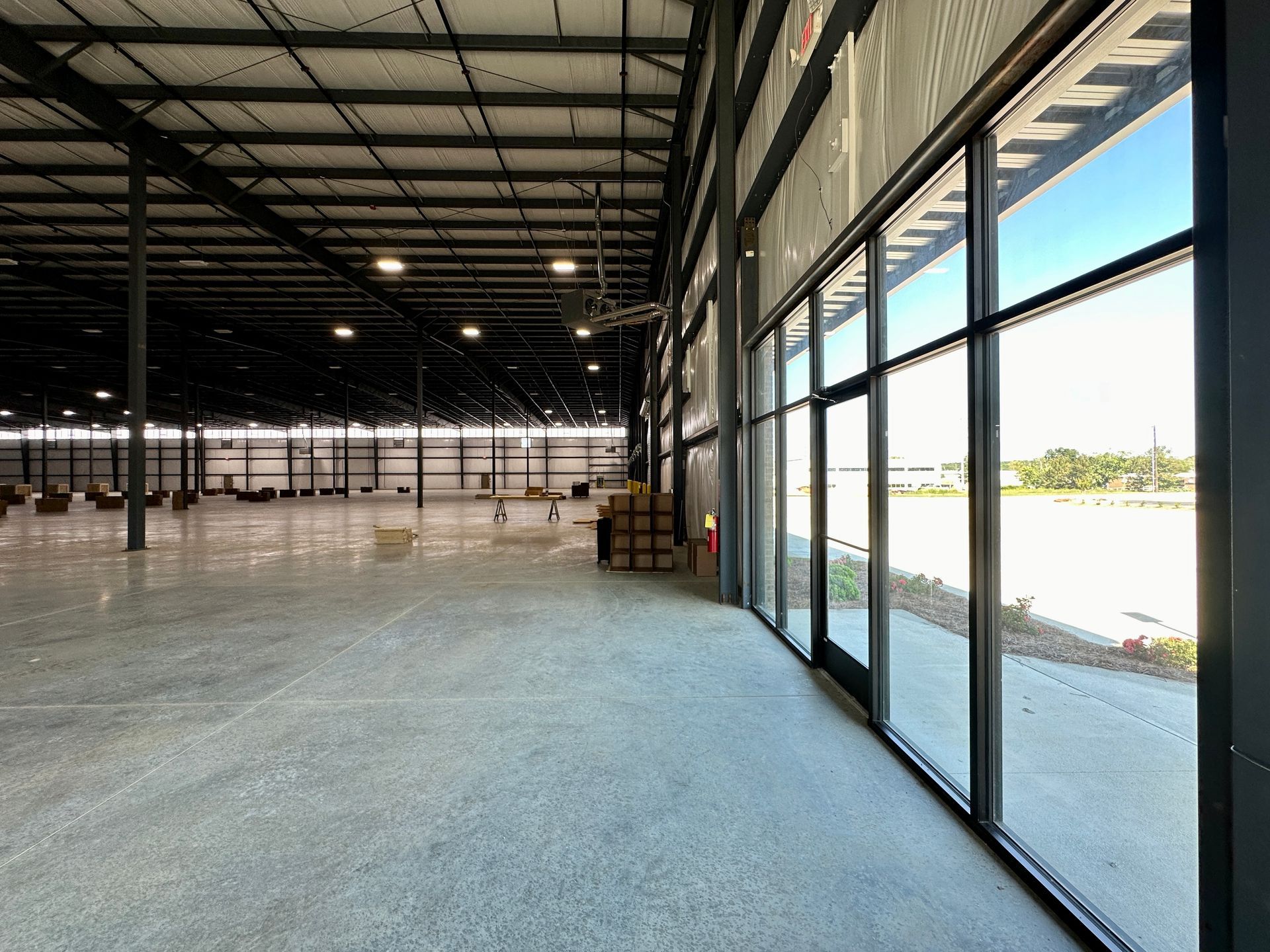A large empty warehouse with a lot of windows